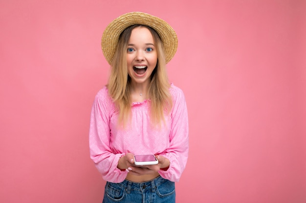 Photo shot of surprised amazed attractive positive good looking young woman wearing casual stylish