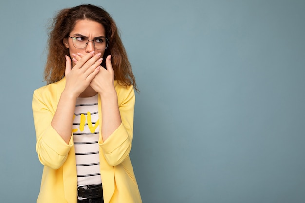 Photo shot of young angry sad nice cute brunette curly woman with sincere emotions wearing trendy