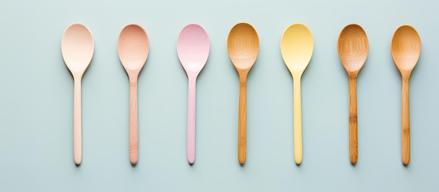 Photo of six spoons arranged in a neat row on a vibrant blue background with copy space