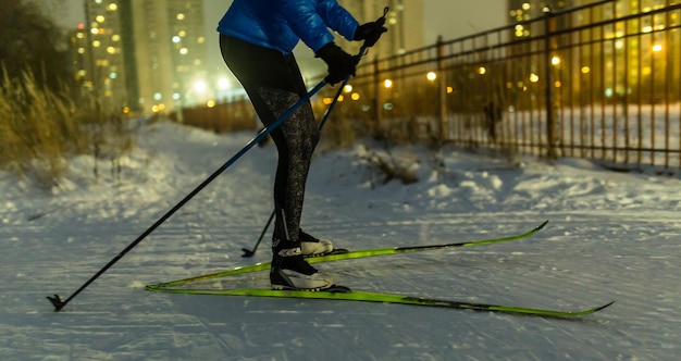 Photo of skier in park in background of house burning lights