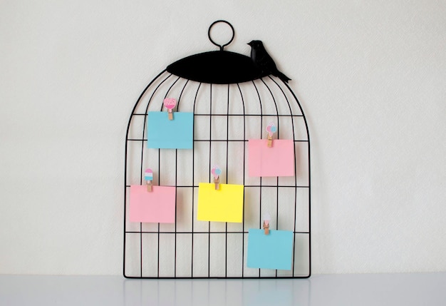 Photo of stacks of colorful stickers and torn paper from a\
notebook, pinned to a blackboard. yellow sticky stickers to remind\
you of the information. space for text.