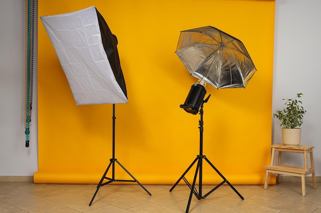 Photo studio and its interior components yellow background and flash