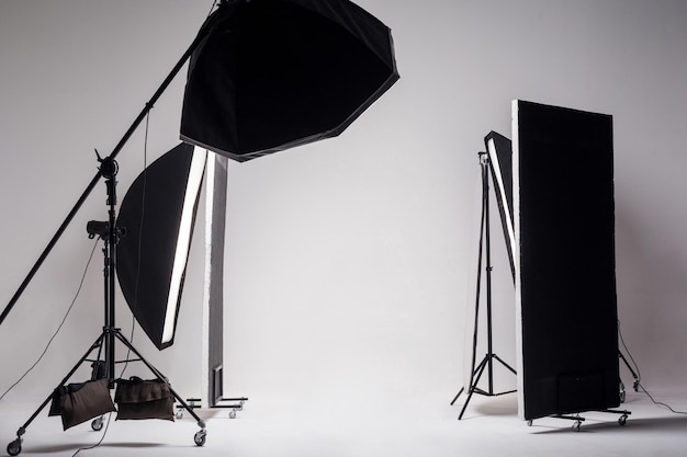 Photo studio with light setup included octagon softbox on boom strip soft box and reflector on light