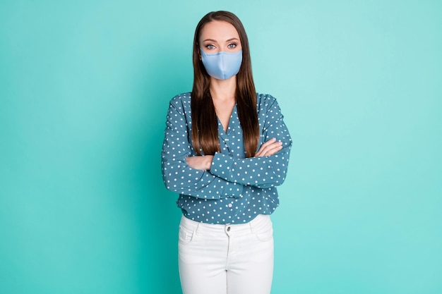 Photo of stunning charming lady cross hands look in camera wear mask isolated over turquoise color background