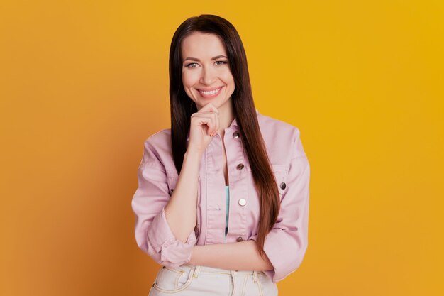 Photo of thoughtful lady arm on chin isolated on yellow background