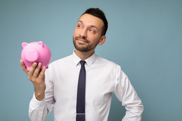 Photo of thoughtful thinking positive selfconfident young handsome brunet unshaven male businessman