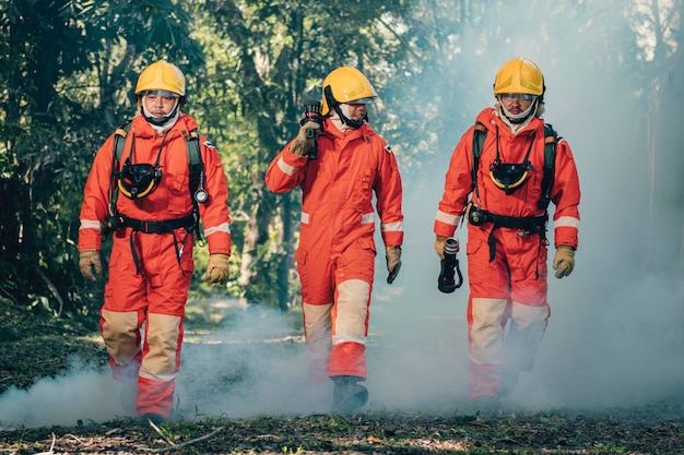 photo of three firefighters walking confidently back after extinguishing a fire