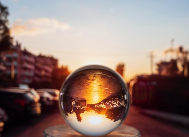 Photo through a glass ball parking of a seaside area of Kallithea at sunset in Athens Greece