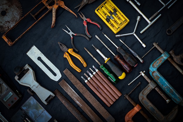 Photo top view a huge set collection of working hand and power tools many for the wooden on isolated black surface