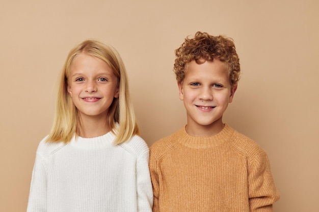 Photo of two children standing next to posing emotions isolated background