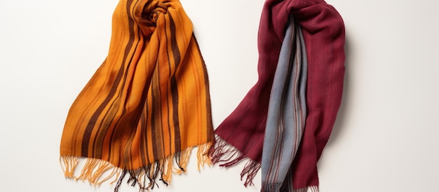 Photo of two colorful scarves hanging on a blank white wall with copy space