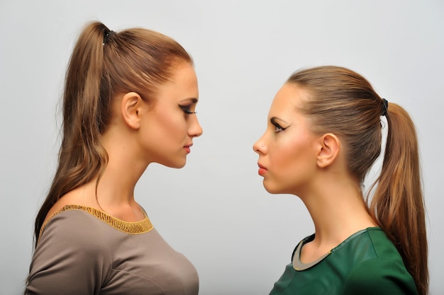 Photo of two girls in the studio looking at each other