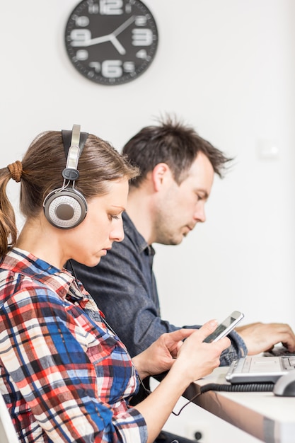 Photo of two people working at the desk