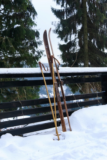 Photo of vintage old wooden skis on the terrace of a country house