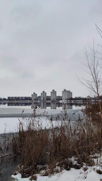 photo of a winter lake against the backdrop of the city