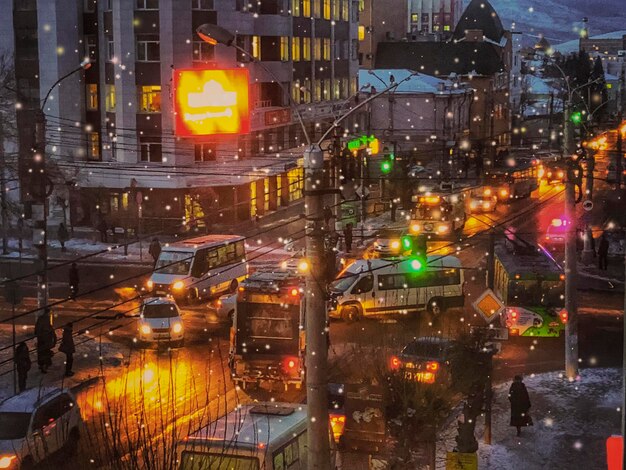 Photo of a winter night in the city with lights and cars