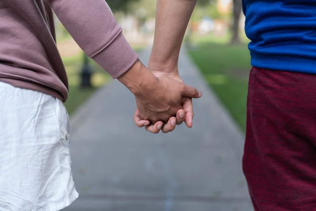 Photo with selective focus of two men holding hands