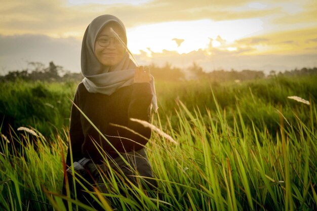 photo of a woman enjoying the sunset