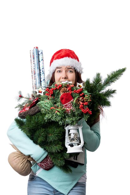 Photo photo of woman in santas cap with christmas tree lantern wrapping paper in hands