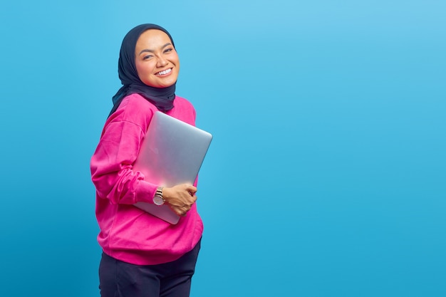 Photo of women Asia hold laptop wear pink sweater isolated on blue color background