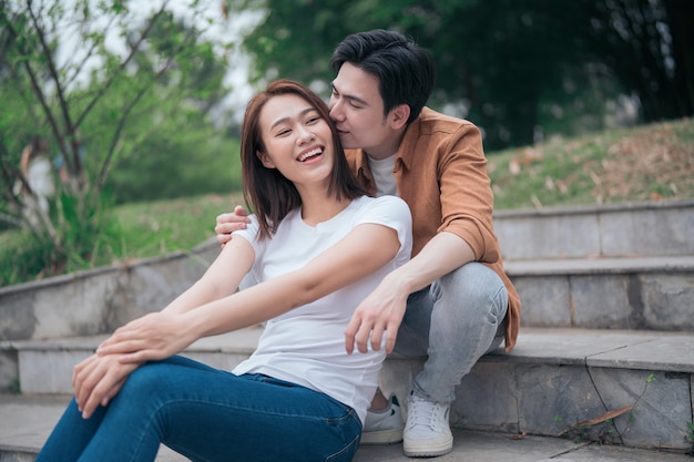 Photo of young Asian couple outside