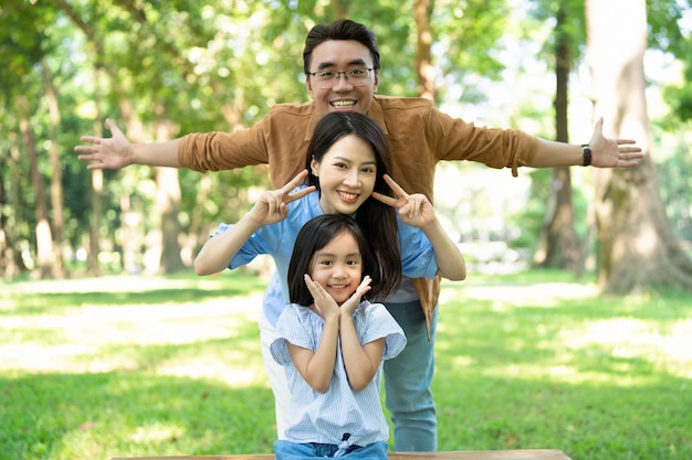 photo of young asian family at park