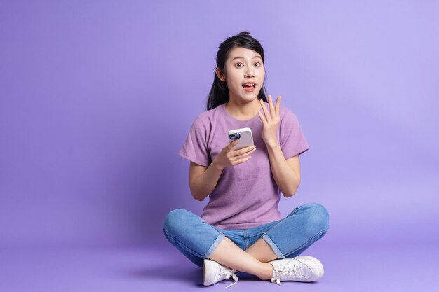 Photo of young Asian girl on purple background