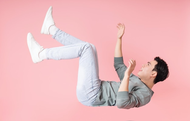 Photo of young Asian man flying on background