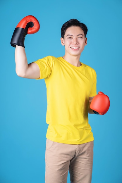 Photo of young asian man with boxing glove