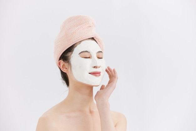 Photo young asian woman doing facial treatment