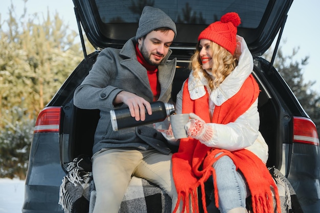 Photo of young attractive couple happy positive smile look each other enjoy time together forest winter love story