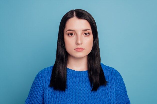 Photo of young attractive woman serious confident smart wear sweater isolated over blue color background