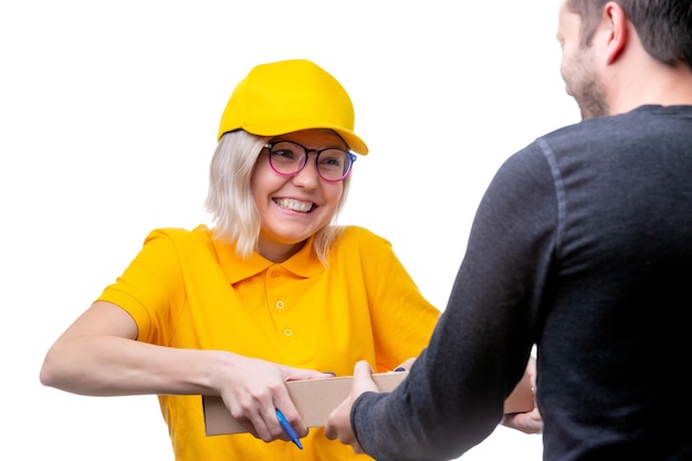 Photo of young blonde courier delivering cardboard box to man