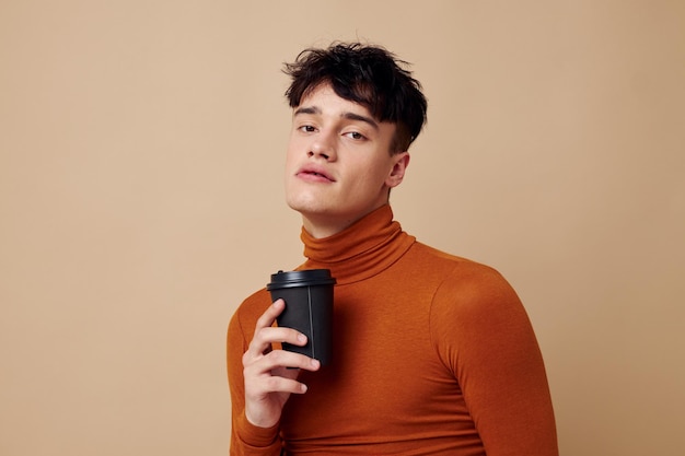 Photo young boyfriend stylish hairstyle brown turtleneck black disposable cup Lifestyle unaltered