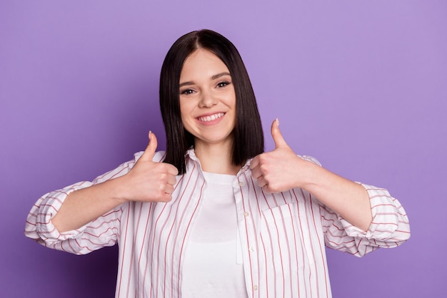 Photo of young cheerful girl show figners thumbsup perfect feedback select isolated over violet color background