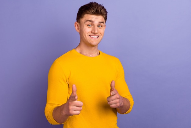 Photo of young cheerful guy indicate fingers choice choose advertising isolated over violet color background