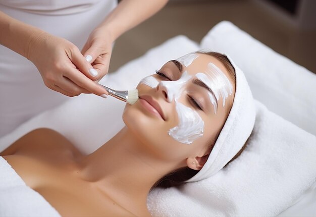 Photo photo of young and cute woman girl getting facial and face mask treatment in salon