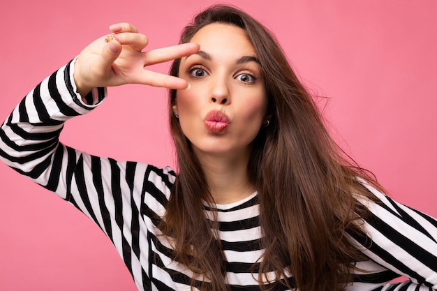 Photo of young european positive winsome sexy beautiful brunette woman with sincere emotions wearing casual striped pullover