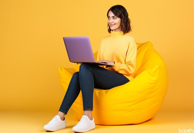 Photo of young girl or boy working with laptop sitting on the floor and chair