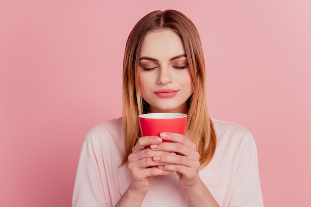 Photo of young girl drink hot americano enjoy smell tasty breal relax isolated pink color background