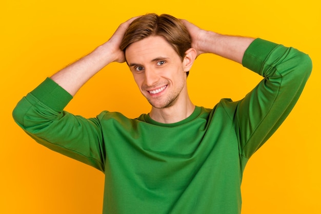 Photo of young guy happy positive smile hands touch hair barber shop lotion isolated over yellow color background