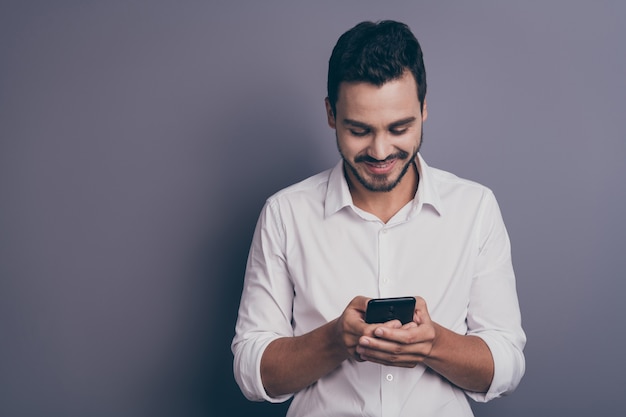 Photo of young handsome business man look telephone screen