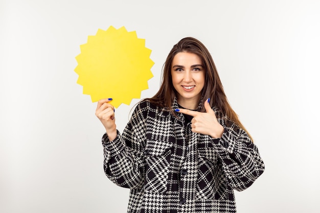 Photo of young lady holding idea board and pointing finger at it