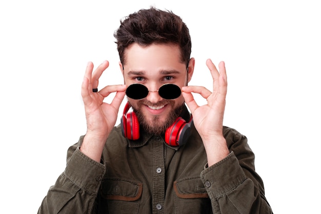 Photo of young man looking suspicious at camera over white background