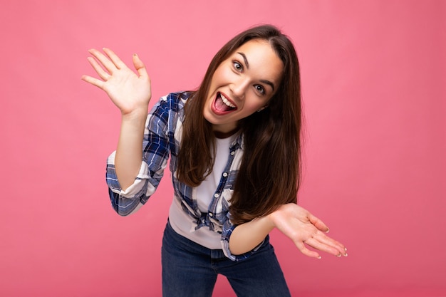 Photo of young positive happy smiling beautiful woman with sincere emotions wearing stylish clothes