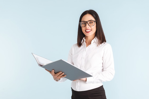 Photo of a young pregnant business woman isolated holding folder.