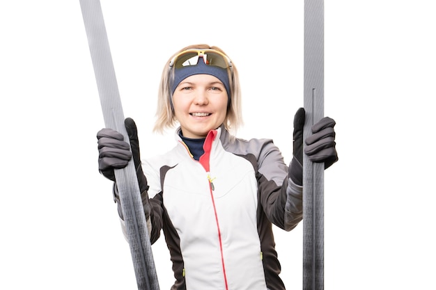 Photo of young sportswoman with skis on empty white background