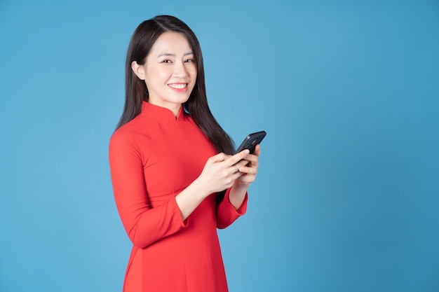 Photo of young Vietnamese woman wearing red ao dai