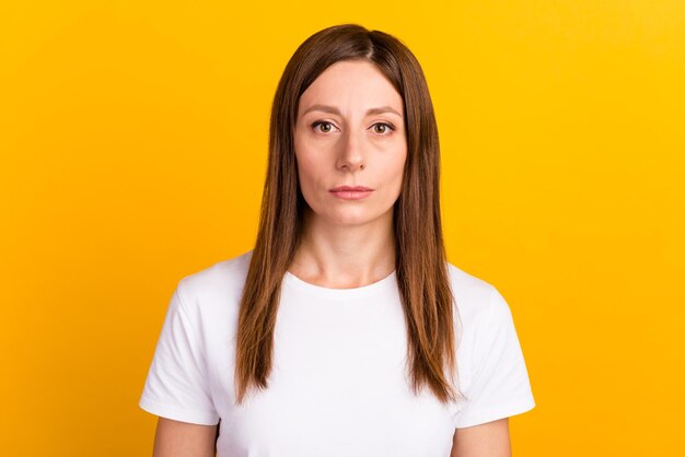 Photo of young woman professional calm look camera isolated over yellow color background