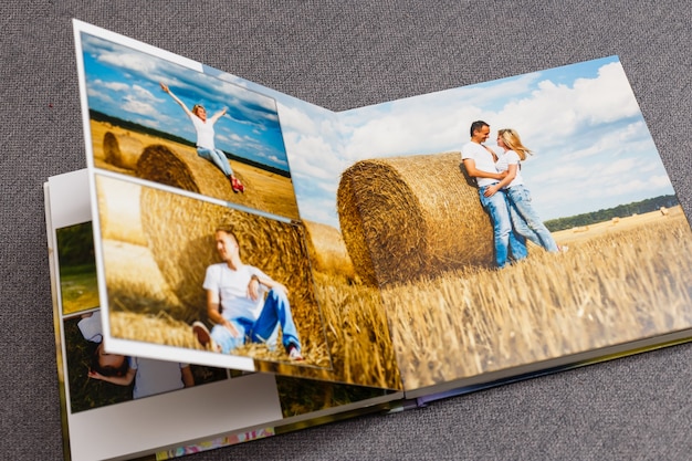 Photo photobook album on deck table with travel photos